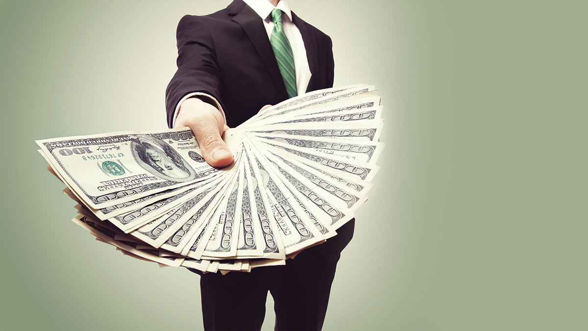 man holding out dollars