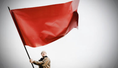 man holding a red flag
