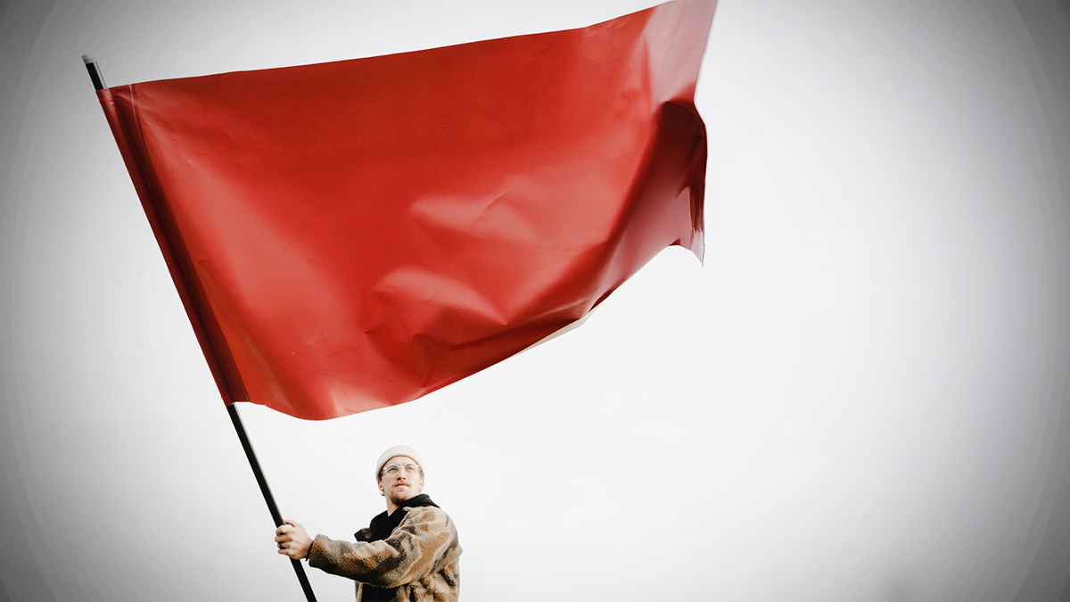 man holding a red flag