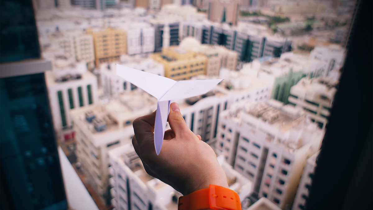 throwing paper plane out the window